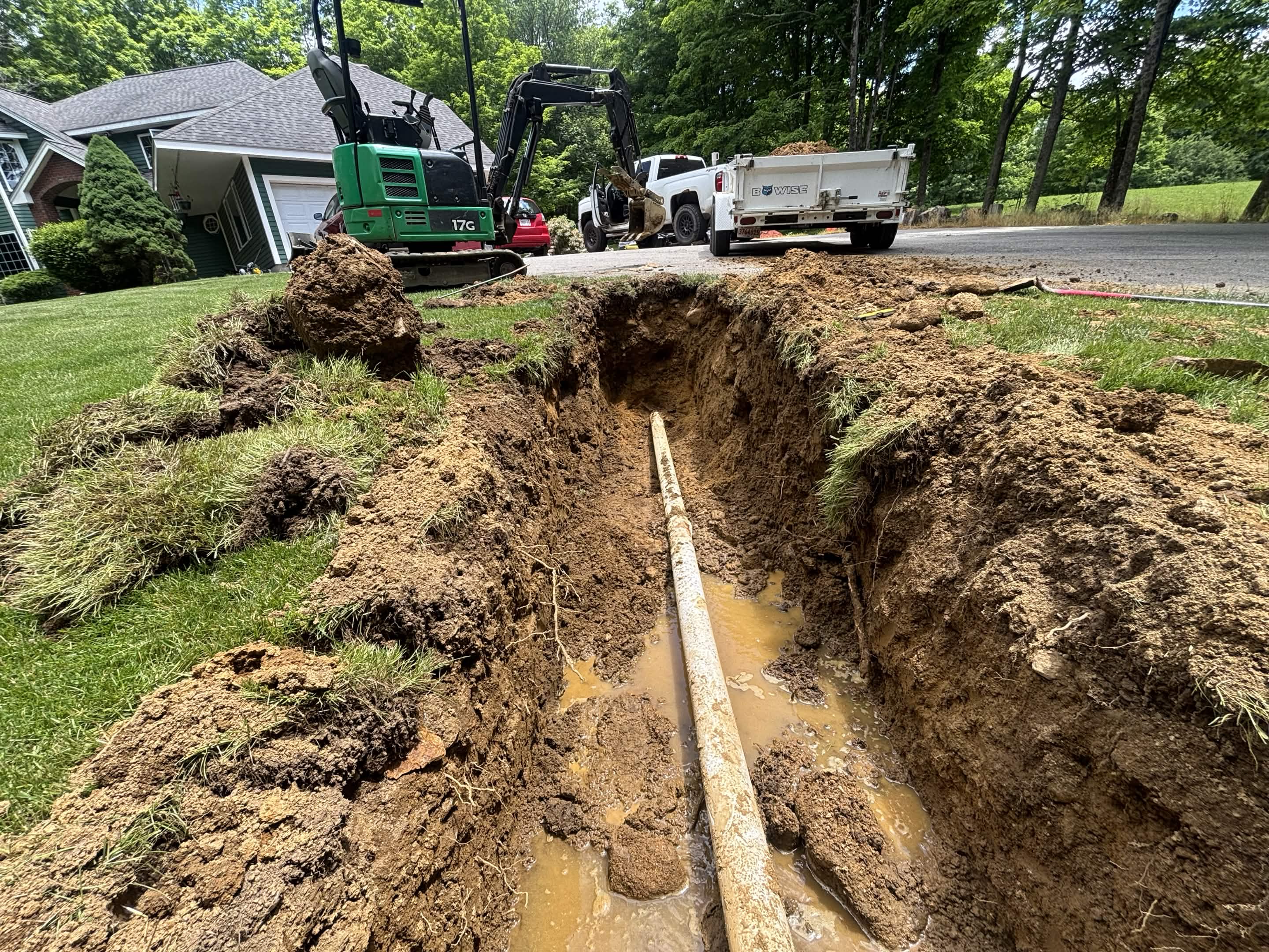 Yard before perimeter drain connected — standing water after rain